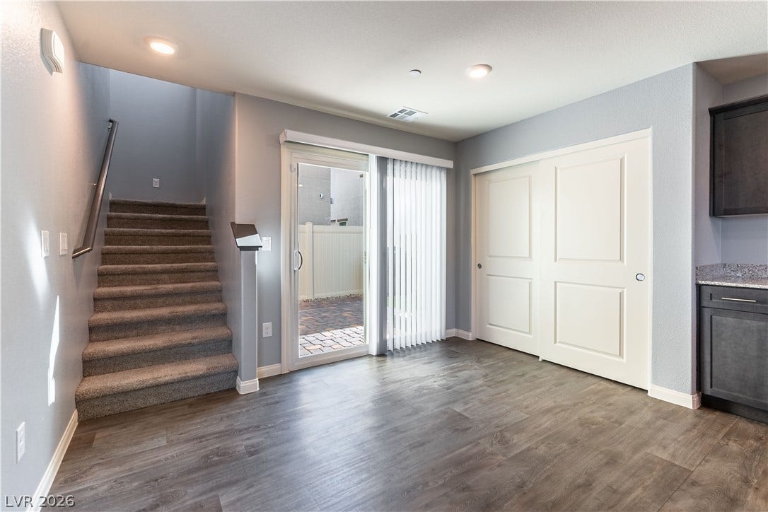 6911 Orange Horizon Street, North Las Vegas, NV 89086 Sliding glass doors open to the patio from this versatile lower-level dining area.