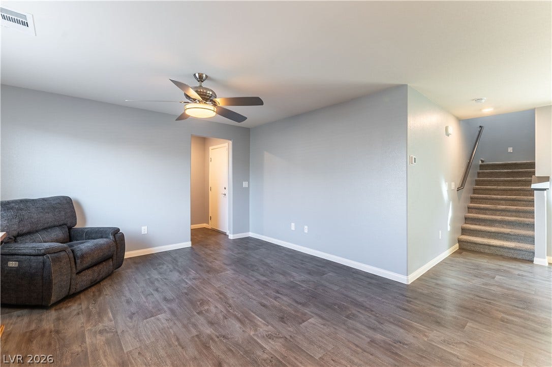 6911 Orange Horizon Street, North Las Vegas, NV 89086 Smooth wood-look flooring and clean lines define this versatile open living space.