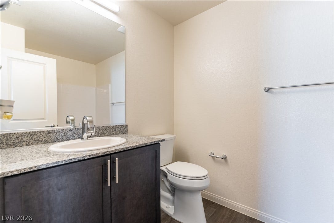 6911 Orange Horizon Street, North Las Vegas, NV 89086 Second upstairs bathroom - A classic vanity with stone counters complements this clean bathroom space.