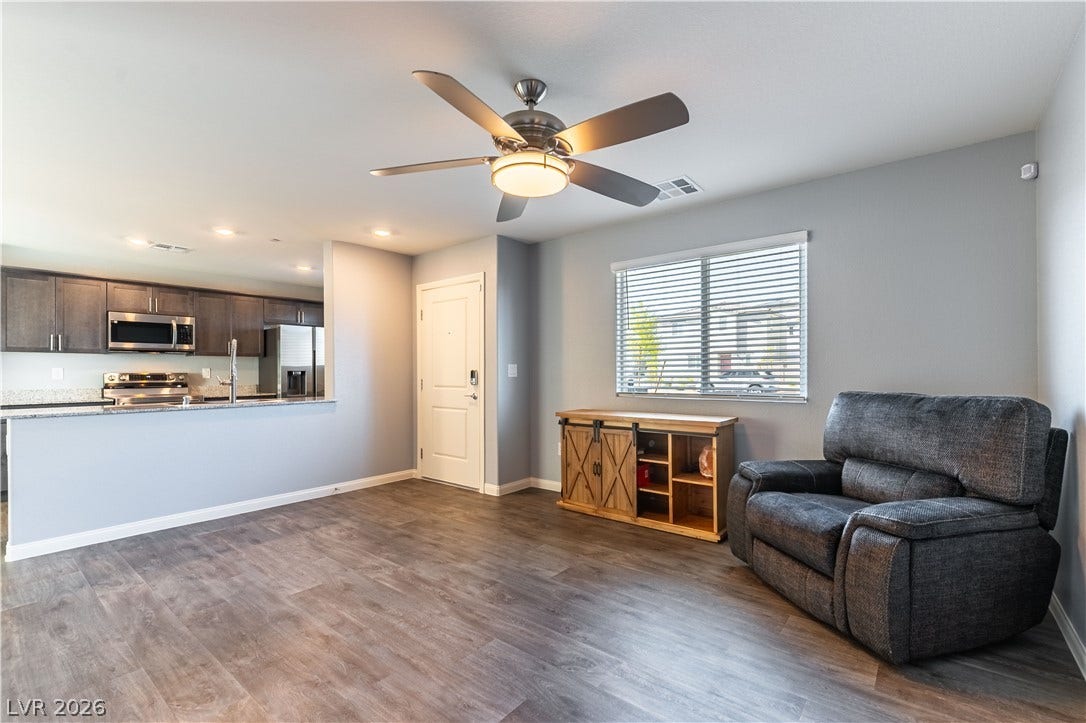 6911 Orange Horizon Street, North Las Vegas, NV 89086 An open floor plan connects the comfortable living space directly to the kitchen area.