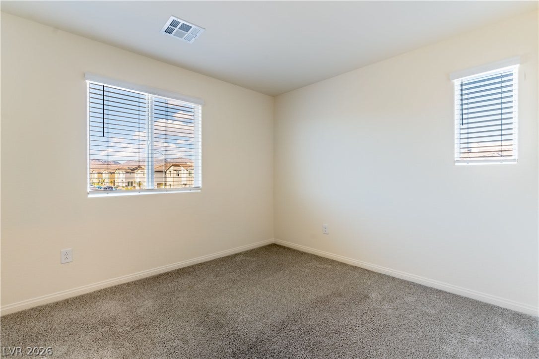 6911 Orange Horizon Street, North Las Vegas, NV 89086 2nd Bedroom - Plush carpeting and natural light define this versatile secondary bedroom space.