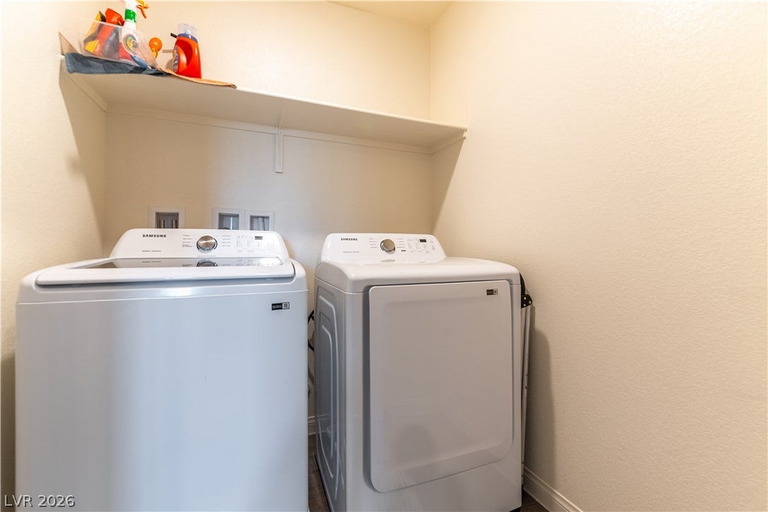 6911 Orange Horizon Street, North Las Vegas, NV 89086 A dedicated laundry space features useful built-in shelving overhead.