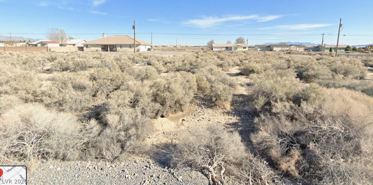2491 Mandy Avenue, Pahrump, NV 89048 An expansive desert lot presents natural brush vegetation under a clear, open sky.
