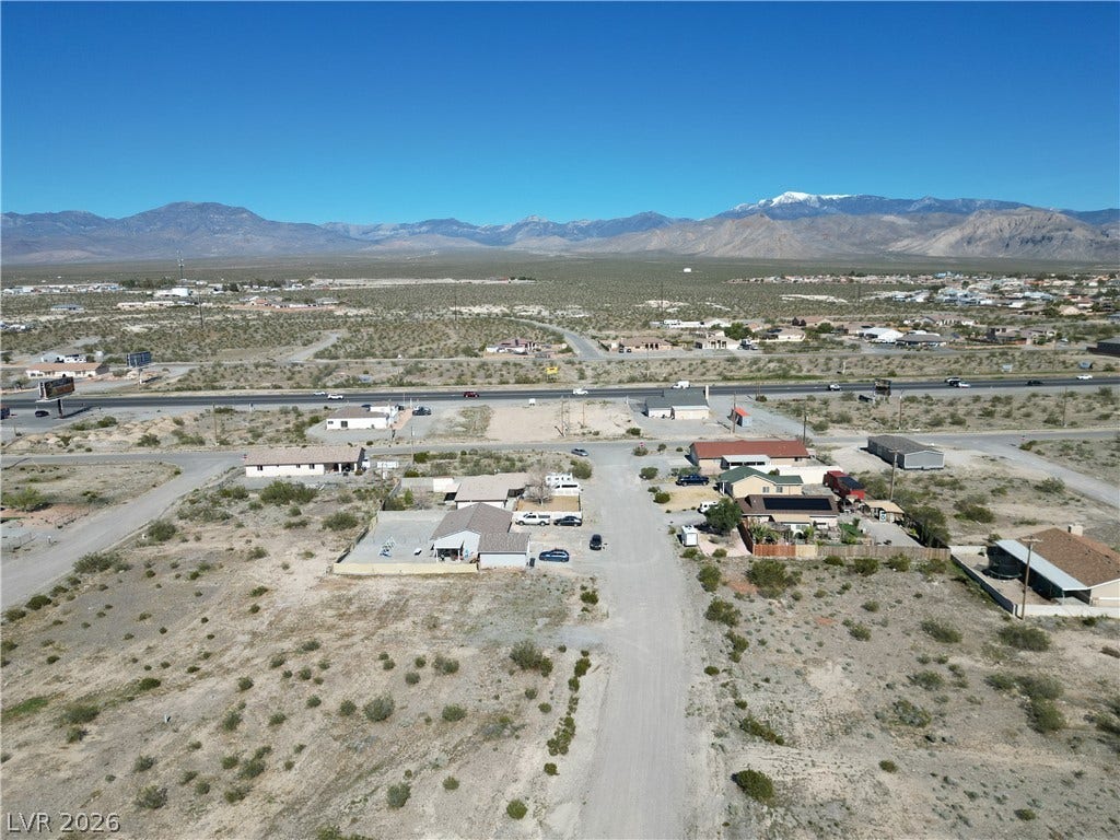 Vast desert horizons surround this aerial perspective featuring majestic mountain views in the distance.