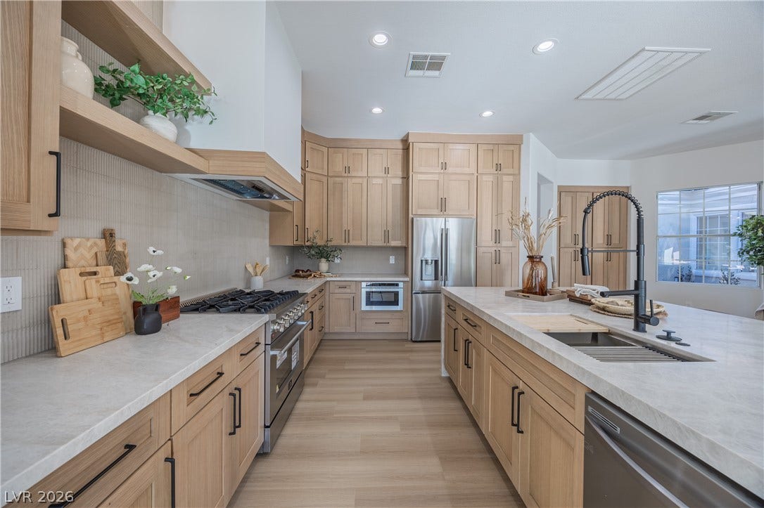 10248 Andante Court, Las Vegas, NV 89135 Kitchen featuring stainless steel appliances, recessed lighting, decorative backsplash, light wood finish cabinets, and light stone counters