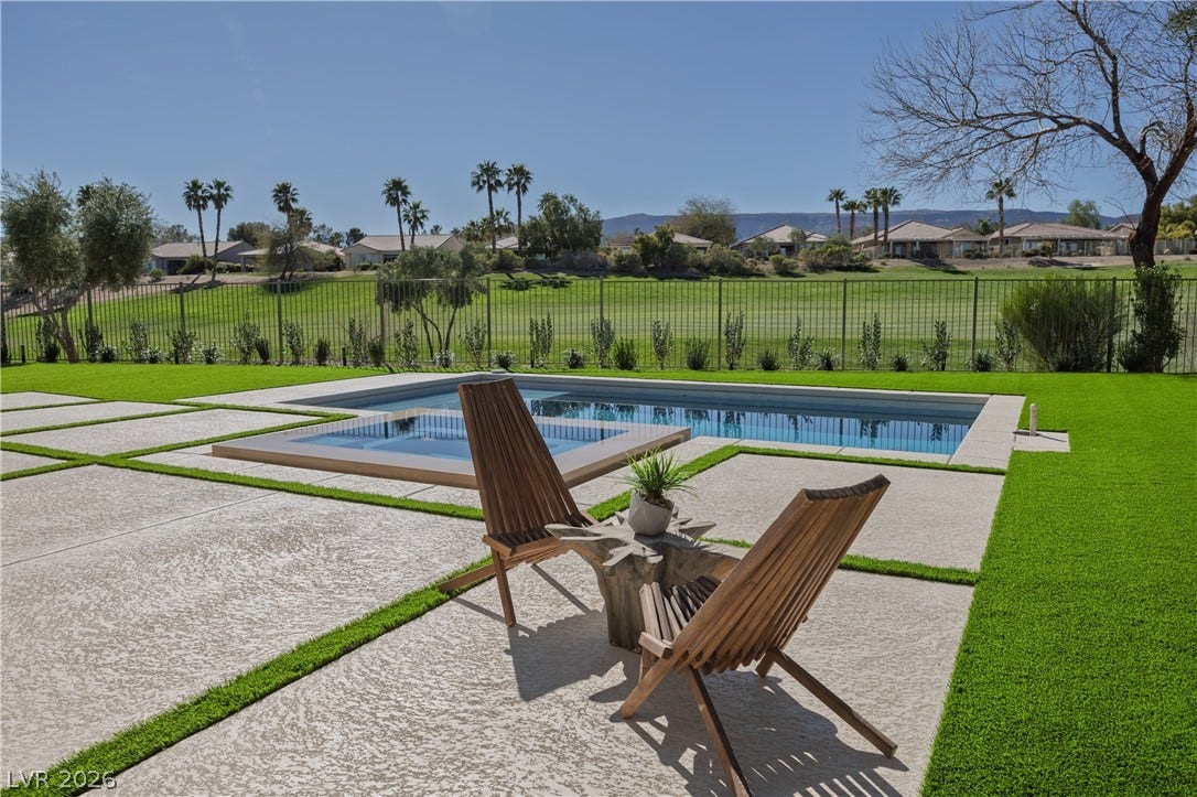 10248 Andante Court, Las Vegas, NV 89135 Integrated pool / hot tub featuring a fenced backyard, a residential view, and a patio area