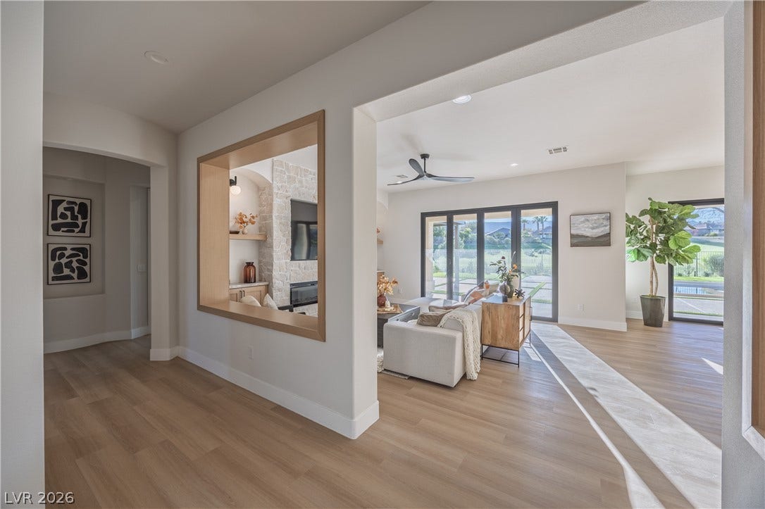 10248 Andante Court, Las Vegas, NV 89135 Living room featuring light wood-style floors, a fireplace, recessed lighting, and a ceiling fan