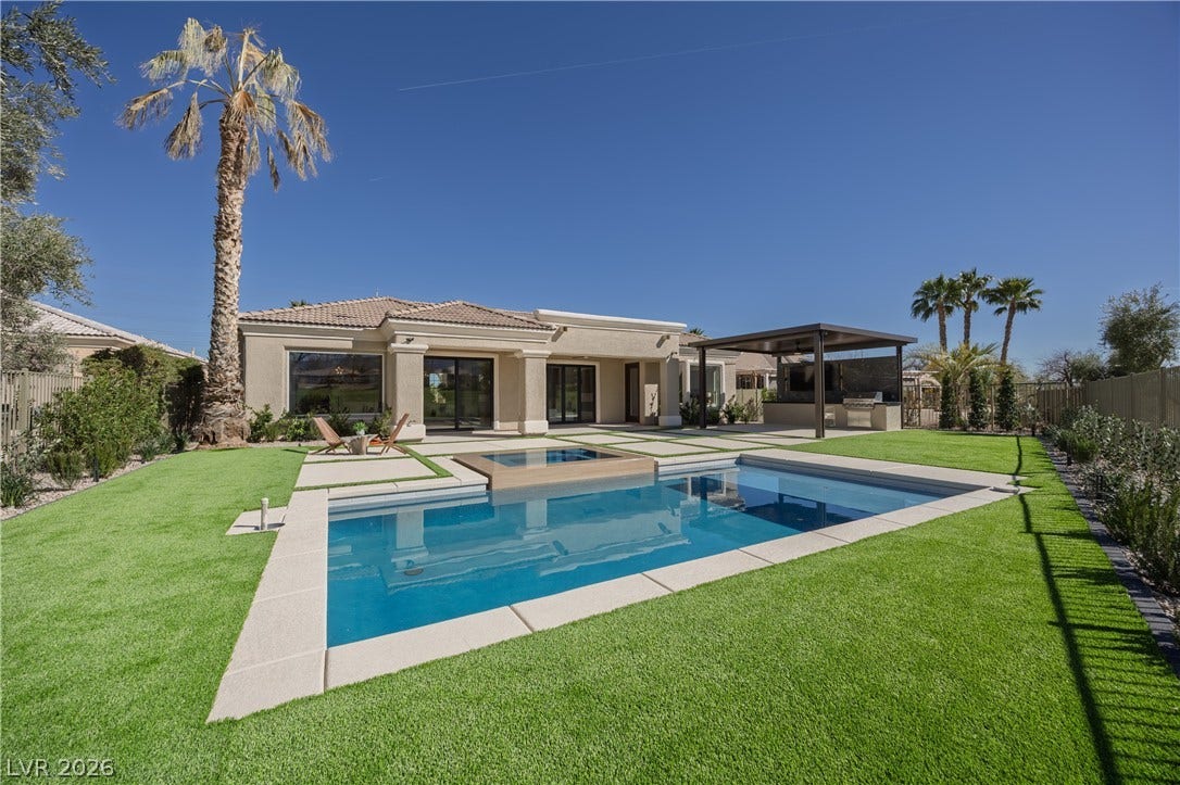 10248 Andante Court, Las Vegas, NV 89135 Back of house with a fenced backyard, a patio, stucco siding, a tile roof, and a pool with connected hot tub