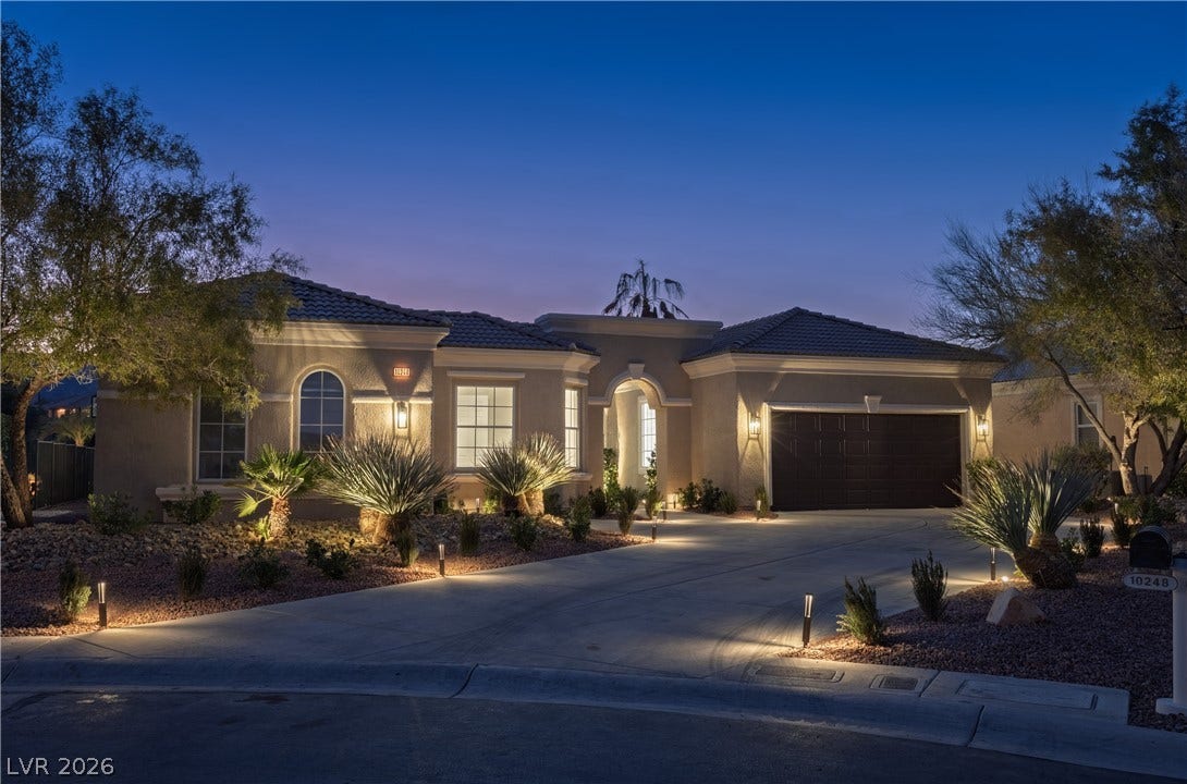 10248 Andante Court, Las Vegas, NV 89135 View of front facade with a garage, a tiled roof, stucco siding, and concrete driveway