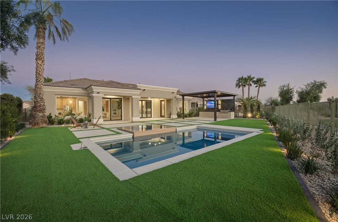 10248 Andante Court, Las Vegas, NV 89135 Back of house at dusk featuring a fenced backyard, a patio area, stucco siding, and a tiled roof