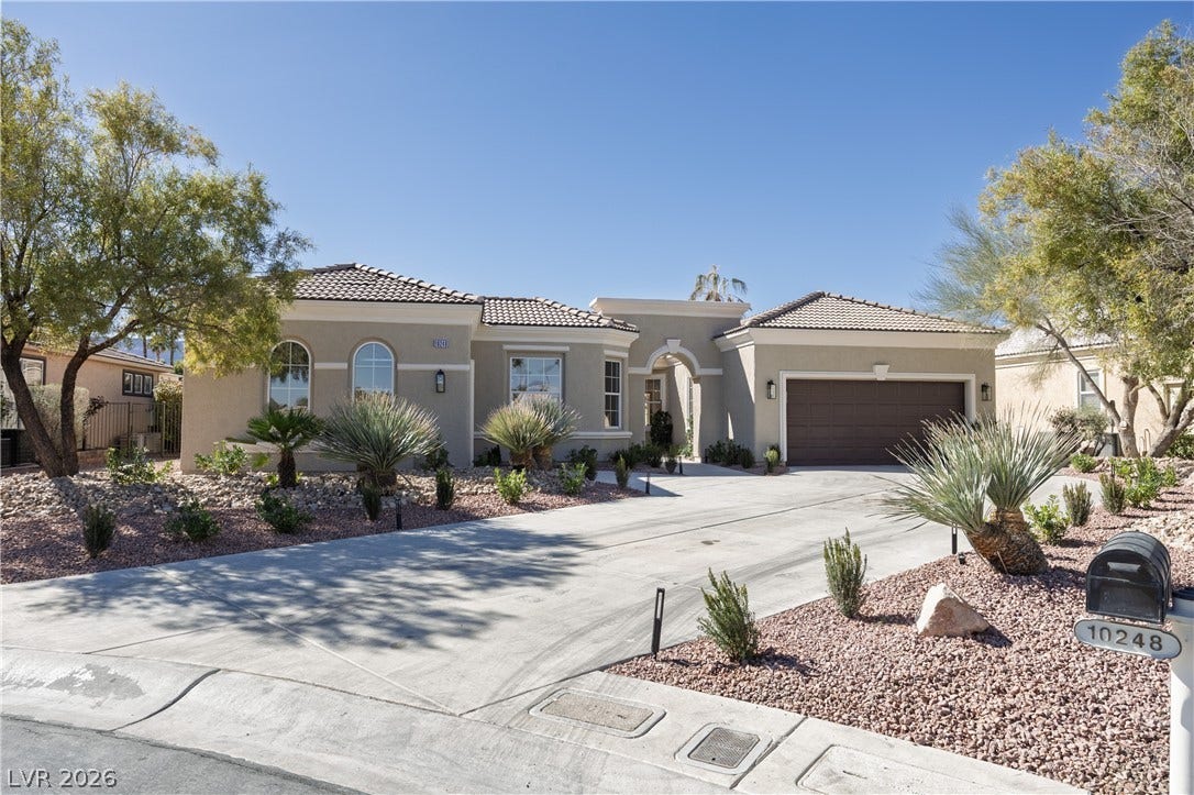 10248 Andante Court, Las Vegas, NV 89135 Mediterranean / spanish house with an attached garage, stucco siding, concrete driveway, and a tile roof
