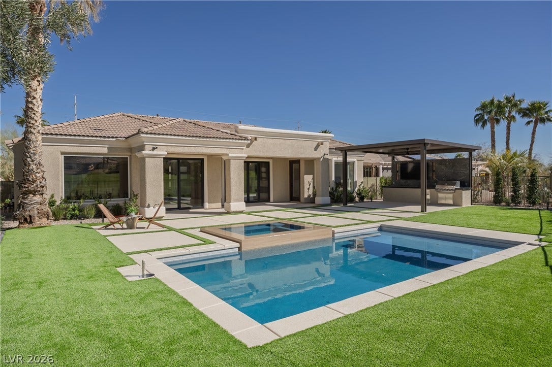 10248 Andante Court, Las Vegas, NV 89135 Rear view of property featuring a patio, stucco siding, a tile roof, exterior kitchen, and a pool with connected hot tub