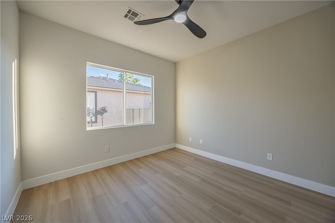 10248 Andante Court, Las Vegas, NV 89135 Unfurnished room with light wood-style flooring and a ceiling fan