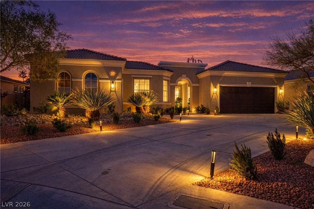 10248 Andante Court, Las Vegas, NV 89135 Mediterranean / spanish-style house with a garage, driveway, stucco siding, and a tile roof