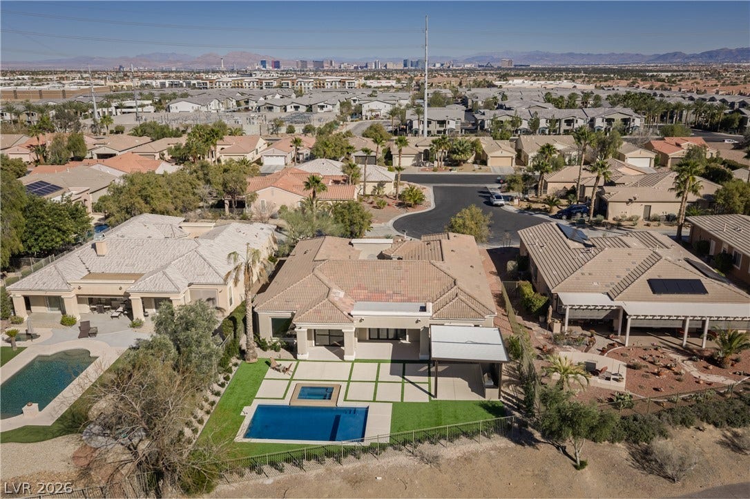10248 Andante Court, Las Vegas, NV 89135 Aerial view of residential area with mountains and a pool area