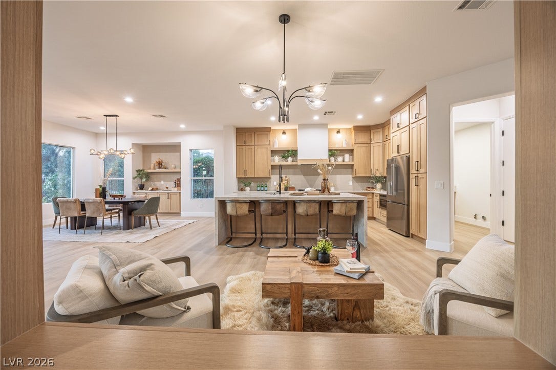 10248 Andante Court, Las Vegas, NV 89135 Living area featuring suspended lighting and light wood finished floors