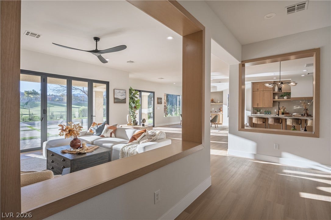 10248 Andante Court, Las Vegas, NV 89135 Living area with wood finished floors, a ceiling fan, and suspended lighting