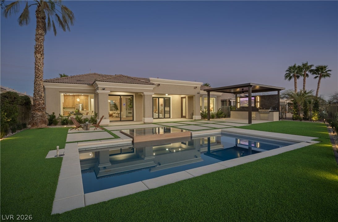 10248 Andante Court, Las Vegas, NV 89135 Back of house at dusk featuring a patio area, stucco siding, a tiled roof, and an outdoor kitchen