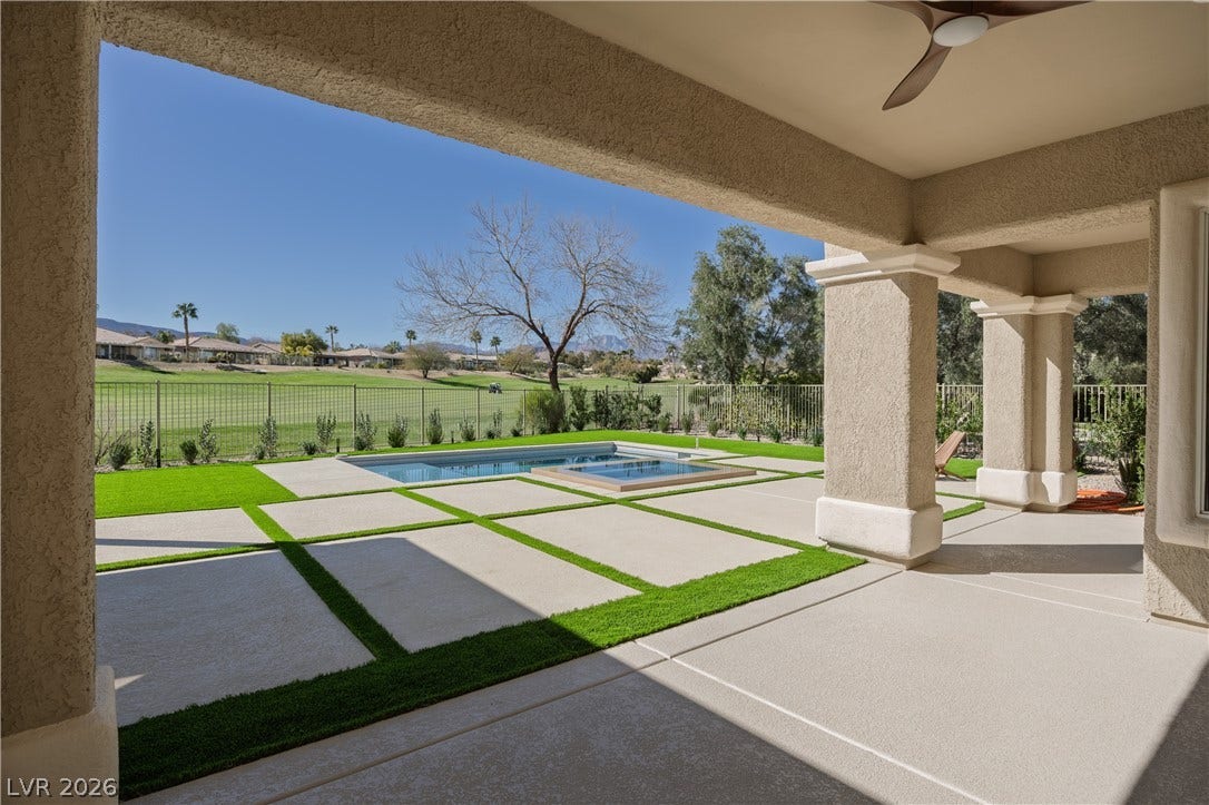10248 Andante Court, Las Vegas, NV 89135 Fenced backyard featuring a patio area, a pool with connected hot tub, a ceiling fan, and a residential view