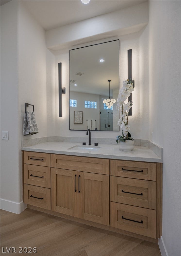 10248 Andante Court, Las Vegas, NV 89135 Bathroom with vanity, recessed lighting, a stall shower, and light wood-style flooring