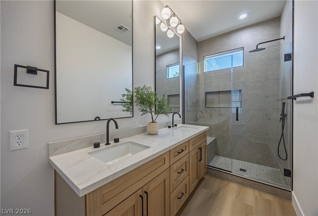 10248 Andante Court, Las Vegas, NV 89135 Full bathroom with double vanity, a shower stall, light wood-style floors, a textured wall, and recessed lighting