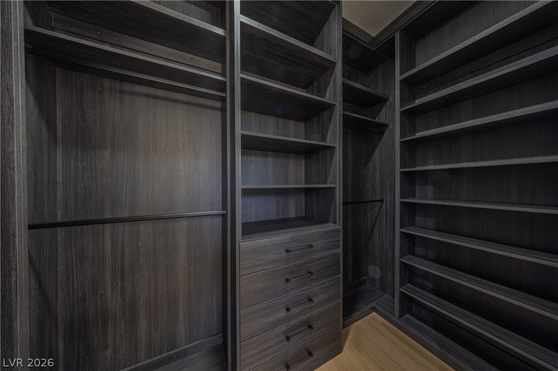 10248 Andante Court, Las Vegas, NV 89135 Walk in closet with light wood-type flooring