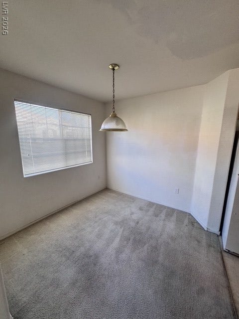 1881 W Alexander Road, #2107, North Las Vegas, NV 89032 Soft carpeting pairs with natural light from a large window in this versatile space.