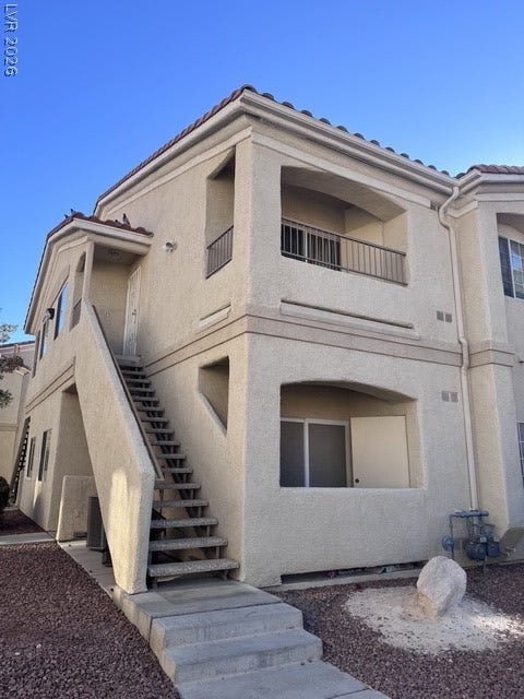 1881 W Alexander Road, #2107, North Las Vegas, NV 89032 Stucco exterior finishes and tiled roofing details highlight this multi-level residential structure.