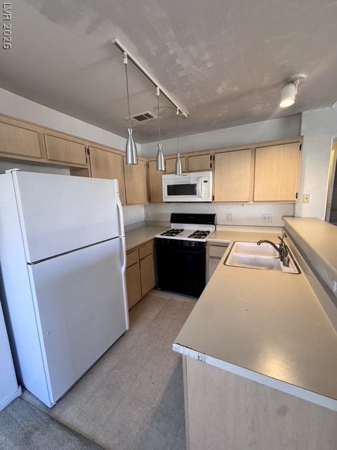 1881 W Alexander Road, #2107, North Las Vegas, NV 89032 Functional kitchen design with wood cabinets and integrated appliances optimized for efficiency.