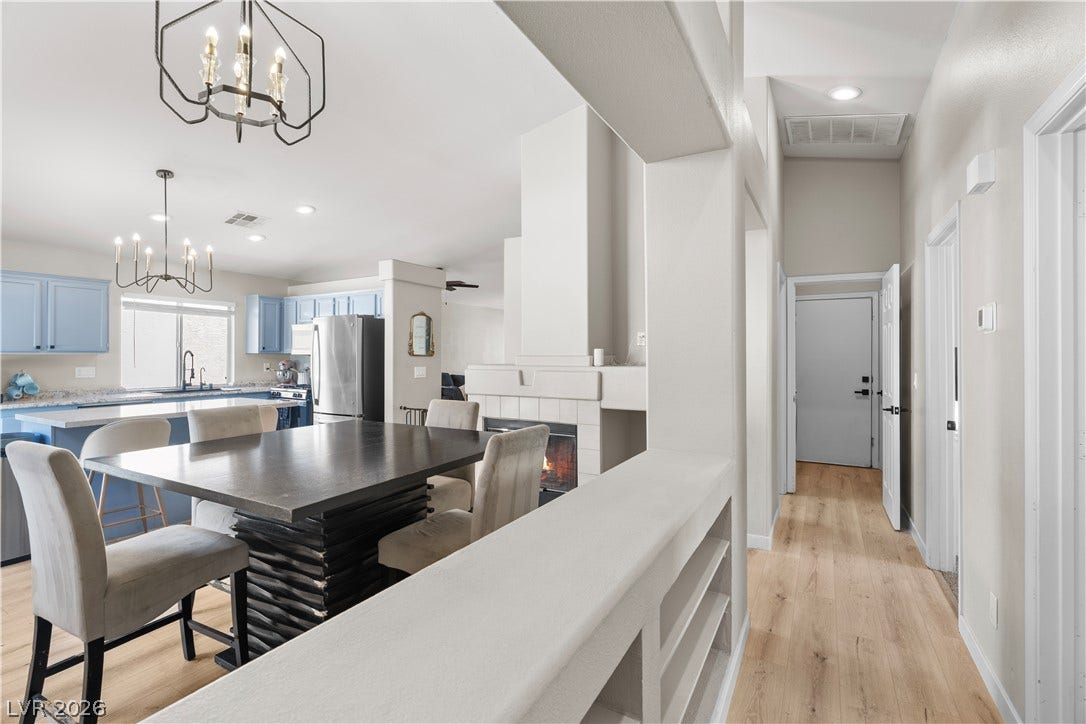 4927 Rancho Domingo Court, North Las Vegas, NV 89031 Smooth wood floors guide the eye toward the open kitchen and cozy fireplace.