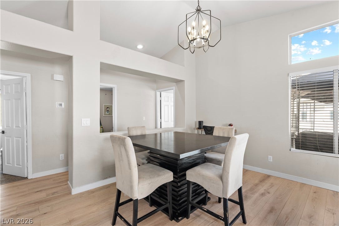 4927 Rancho Domingo Court, North Las Vegas, NV 89031 High ceilings and clean wood-plank flooring define this open dining space.
