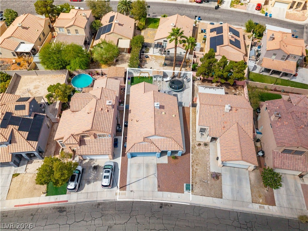 4927 Rancho Domingo Court, North Las Vegas, NV 89031 An overhead perspective highlights the tile roof and fenced backyard of this suburban home.