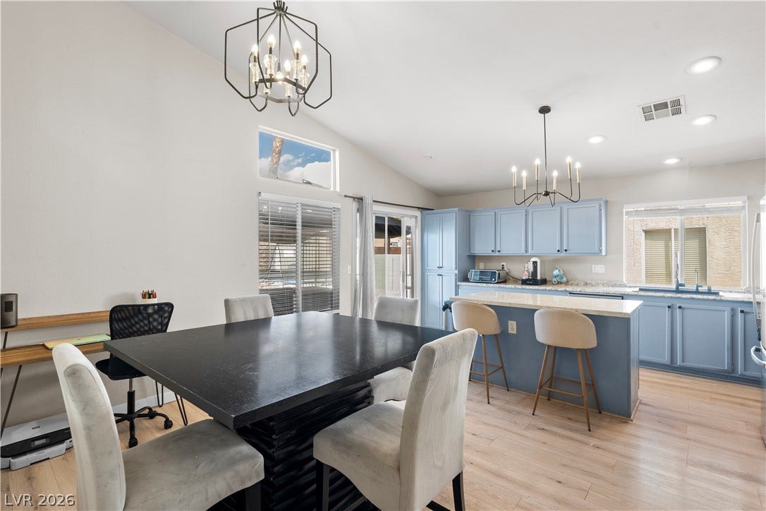 4927 Rancho Domingo Court, North Las Vegas, NV 89031 High vaulted ceilings and wood-style flooring elevate this open-concept kitchen and dining area.