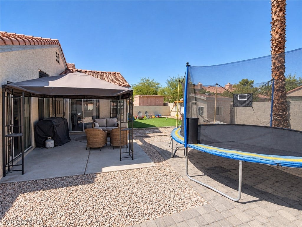 4927 Rancho Domingo Court, North Las Vegas, NV 89031 An inviting tiled-roof home opens to a concrete patio and a gravel-scaped backyard.