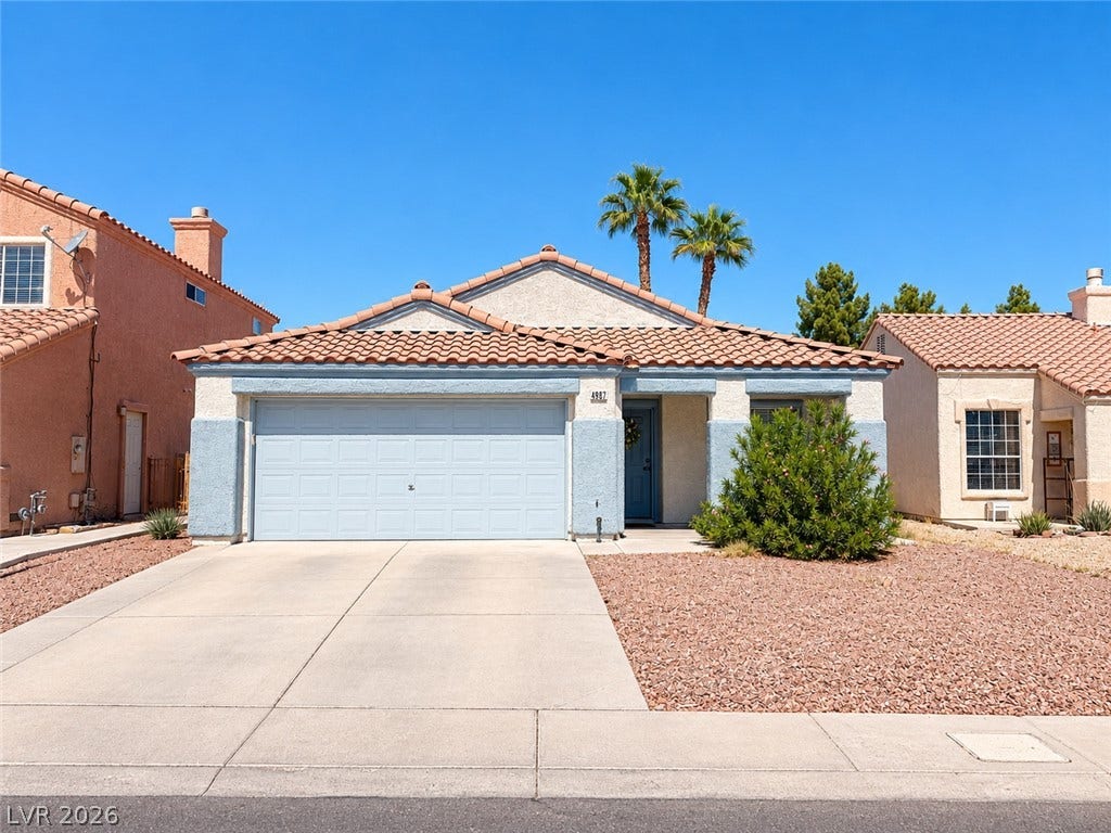 4927 Rancho Domingo Court, North Las Vegas, NV 89031 A classic tiled roof and low-maintenance desert landscaping frame this single-story suburban residence.