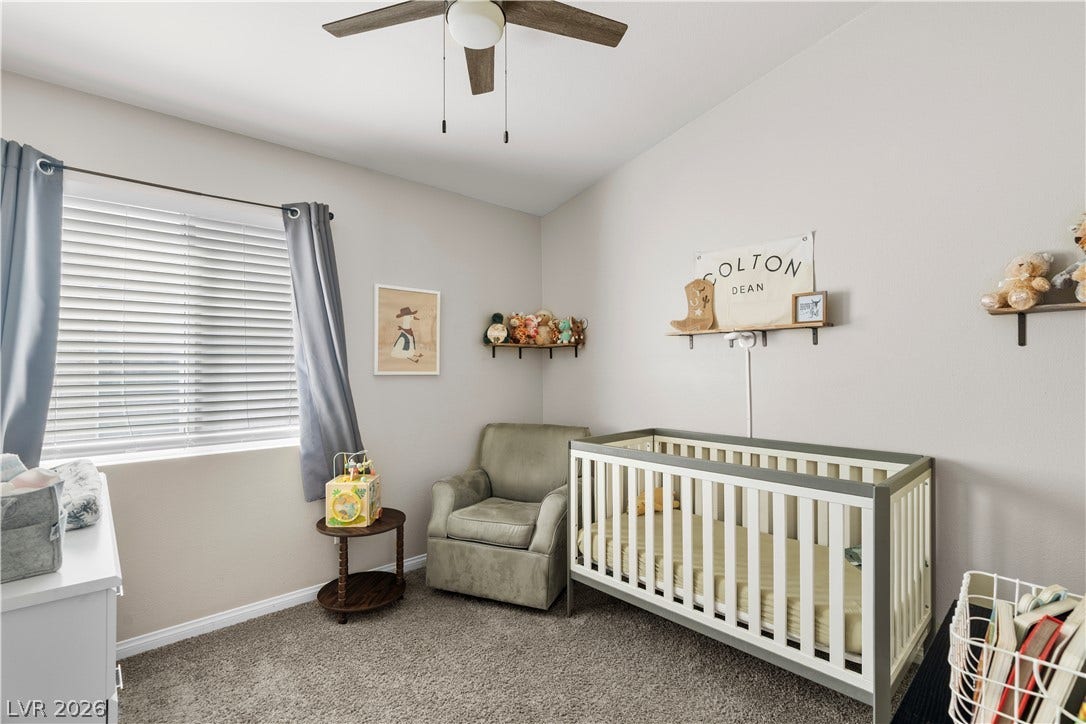 4927 Rancho Domingo Court, North Las Vegas, NV 89031 Plush wall-to-wall carpeting and a wide window with integrated blinds highlight this cozy secondary bedroom.