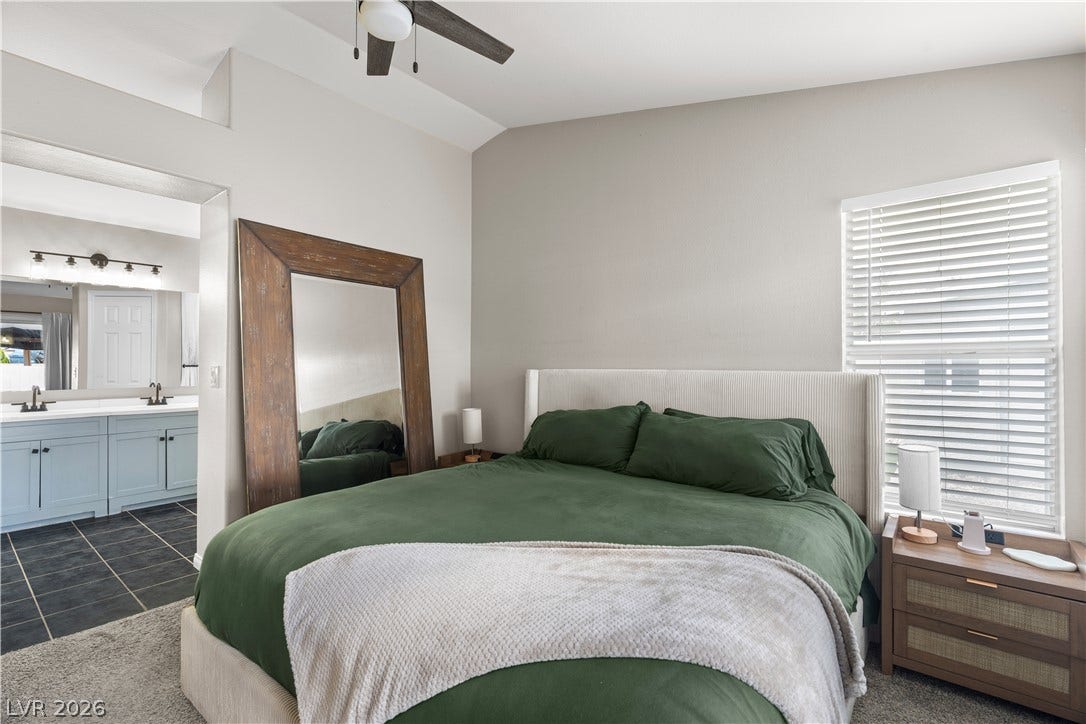 4927 Rancho Domingo Court, North Las Vegas, NV 89031 High vaulted ceilings and plush carpeting define this serene master suite with an attached bathroom.