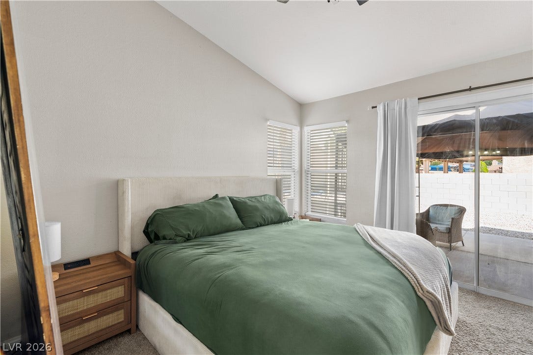 4927 Rancho Domingo Court, North Las Vegas, NV 89031 Sliding glass doors open directly to the back patio from this vaulted bedroom.