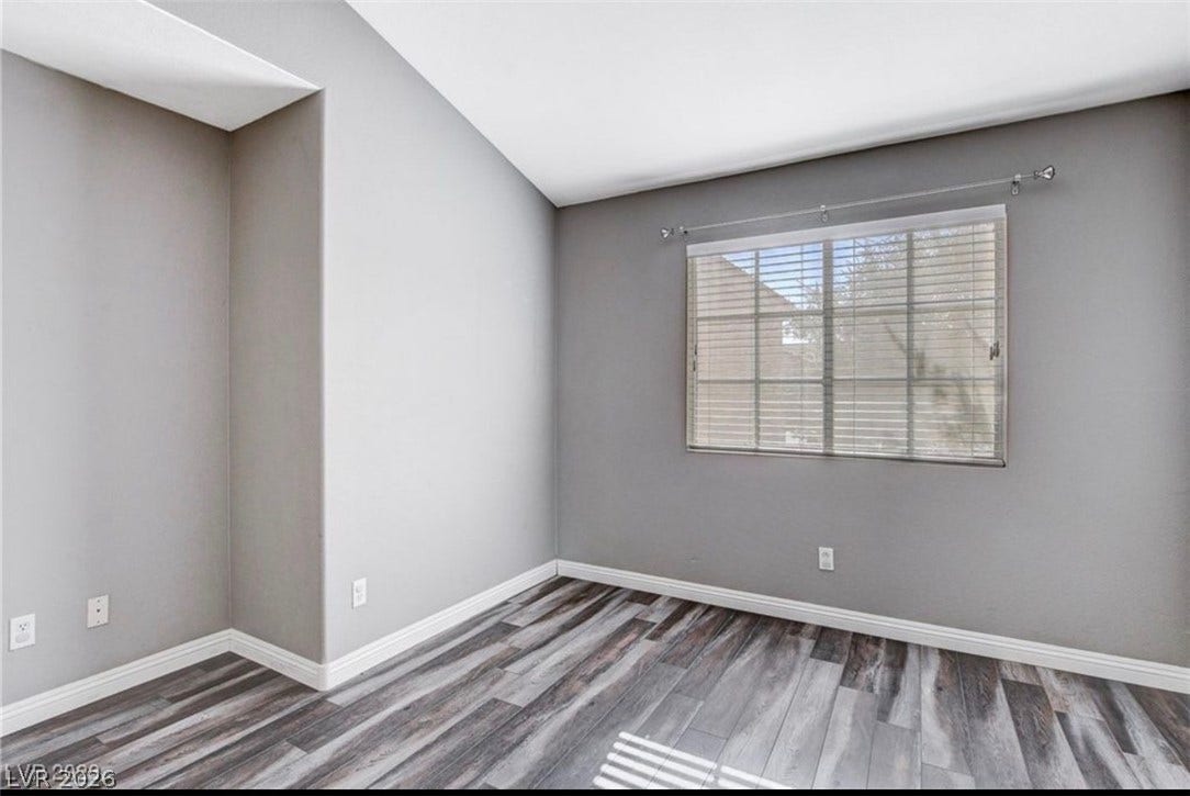 2514 Inlet Spring Avenue, North Las Vegas, NV 89031 Angled ceilings and wood-look flooring define this versatile secondary room.