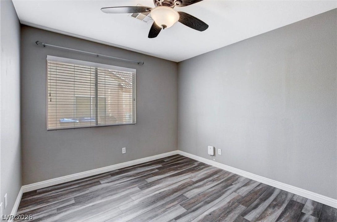 2514 Inlet Spring Avenue, North Las Vegas, NV 89031 Gleaming wood-look floors anchor this versatile room illuminated by a generous window.