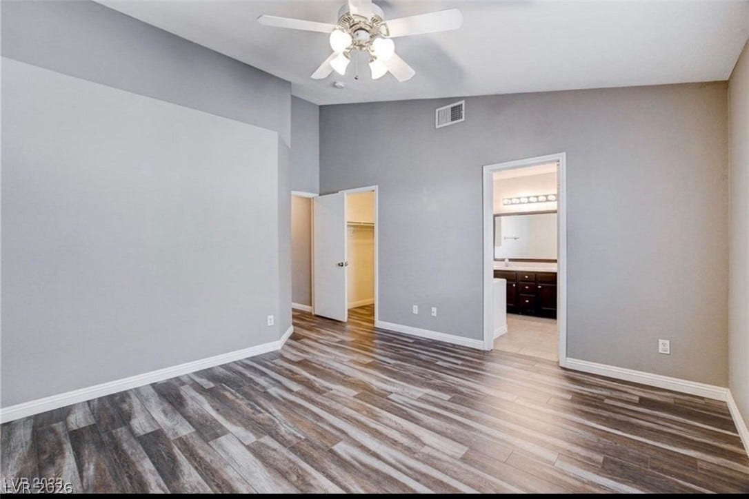 2514 Inlet Spring Avenue, North Las Vegas, NV 89031 High vaulted ceilings and wood-look flooring define this main level bedroom suite.