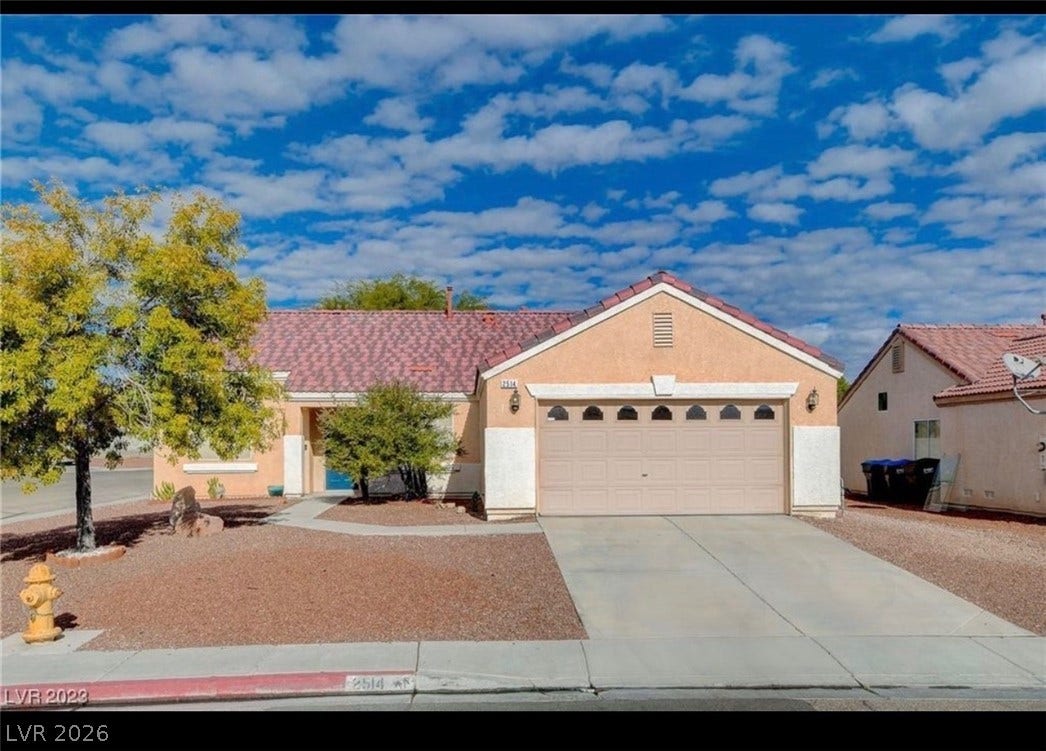 2514 Inlet Spring Avenue, North Las Vegas, NV 89031 Classic desert landscaping accents this single-story residence with an attached garage.