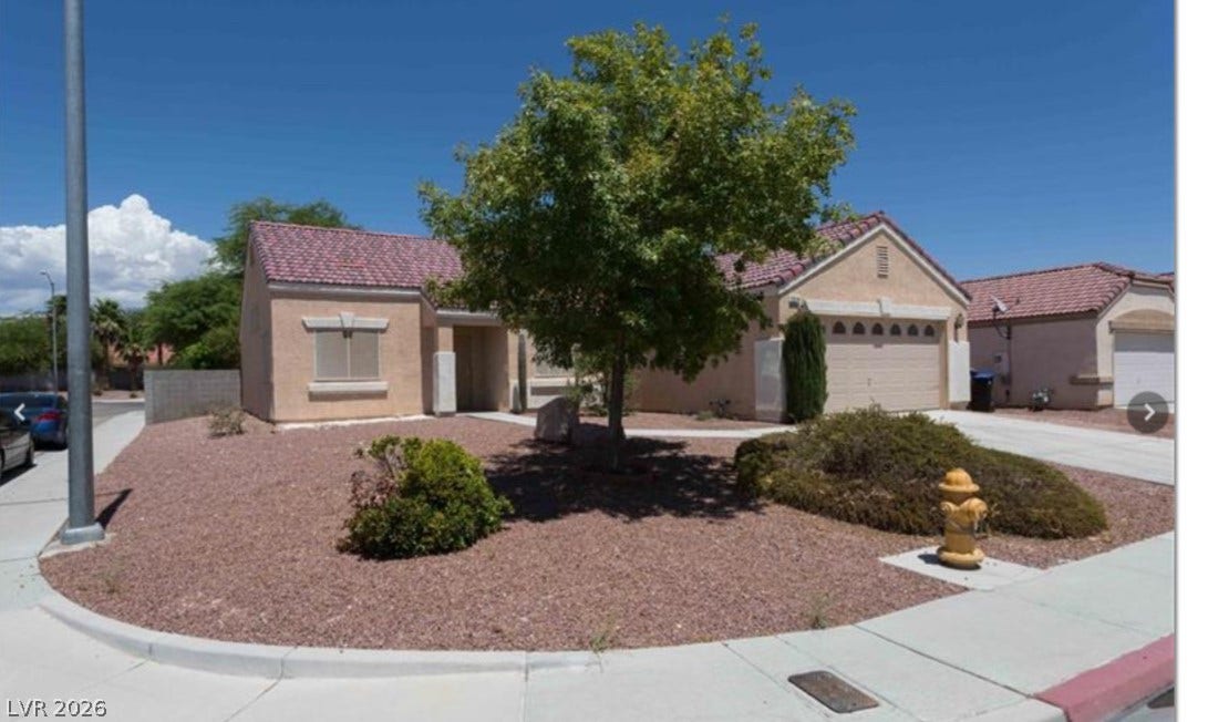 2514 Inlet Spring Avenue, North Las Vegas, NV 89031 Low-maintenance desert landscaping frames the front exterior of this single-story home with tiled roofing.