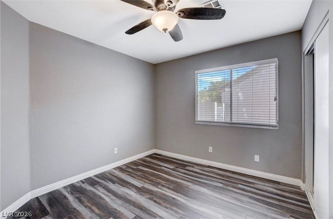 2514 Inlet Spring Avenue, North Las Vegas, NV 89031 Hardwood floors and a wide window with integrated blinds highlight this versatile bedroom.