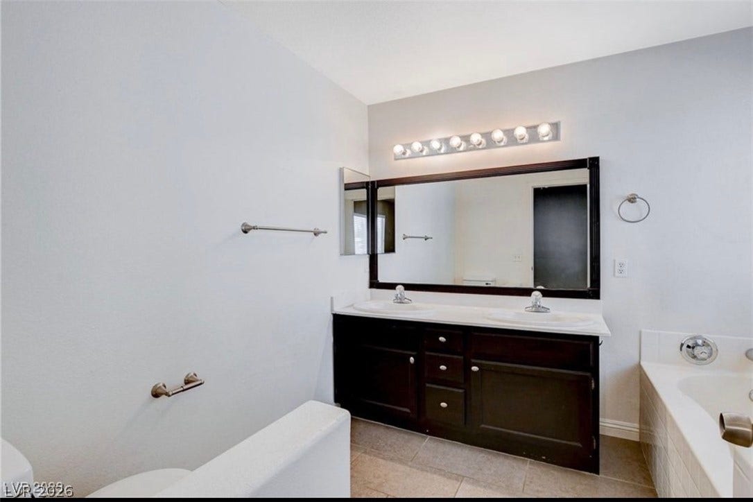 2514 Inlet Spring Avenue, North Las Vegas, NV 89031 Clean lines and a spacious double vanity define this well-appointed master bathroom.