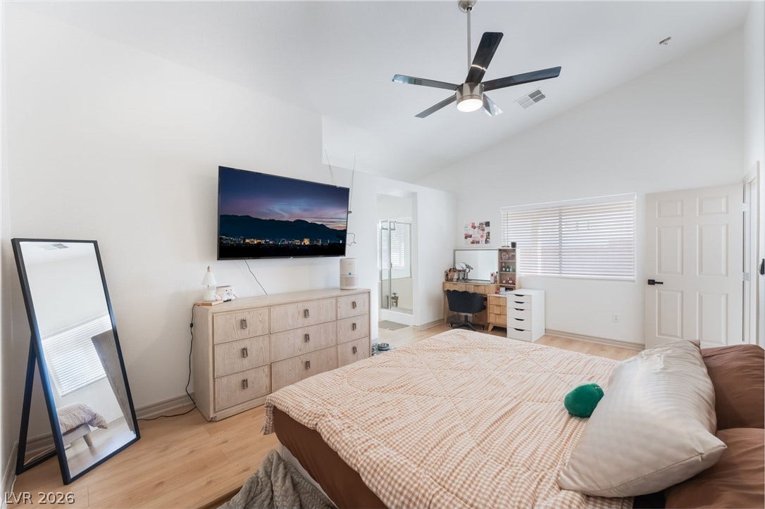 3729 Shimmering Creek Avenue, North Las Vegas, NV 89031 High vaulted ceilings and rich wood floors anchor this comfortable bedroom retreat.
