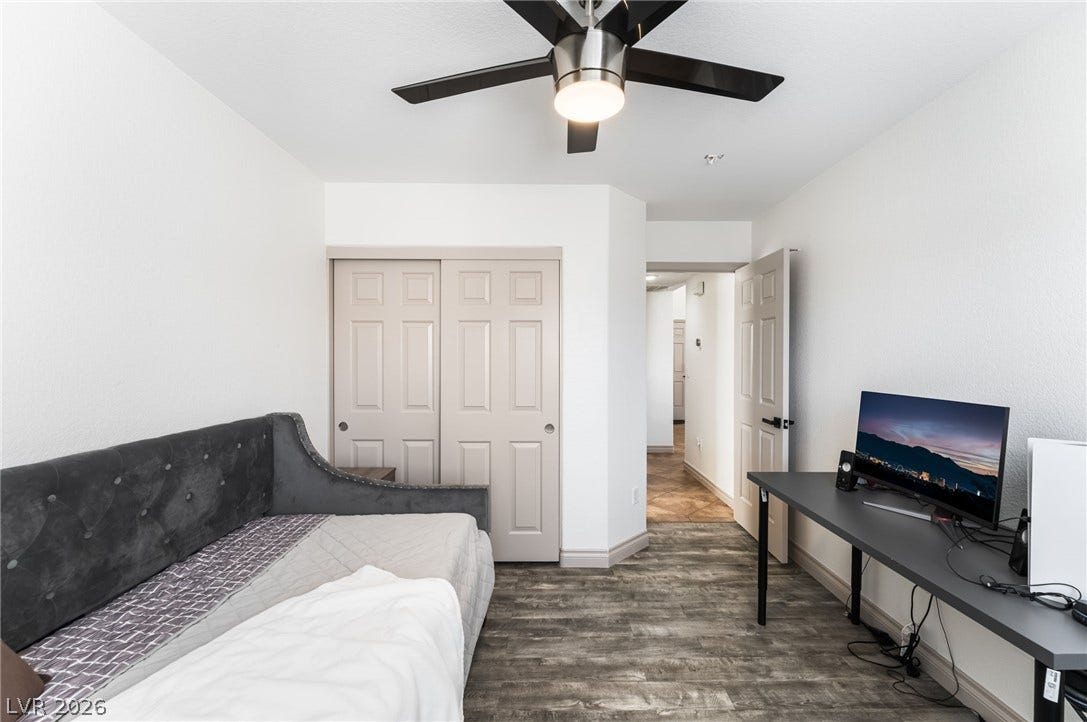 3729 Shimmering Creek Avenue, North Las Vegas, NV 89031 Plank-style flooring and neutral walls define this versatile space, opening to the hallway beyond.