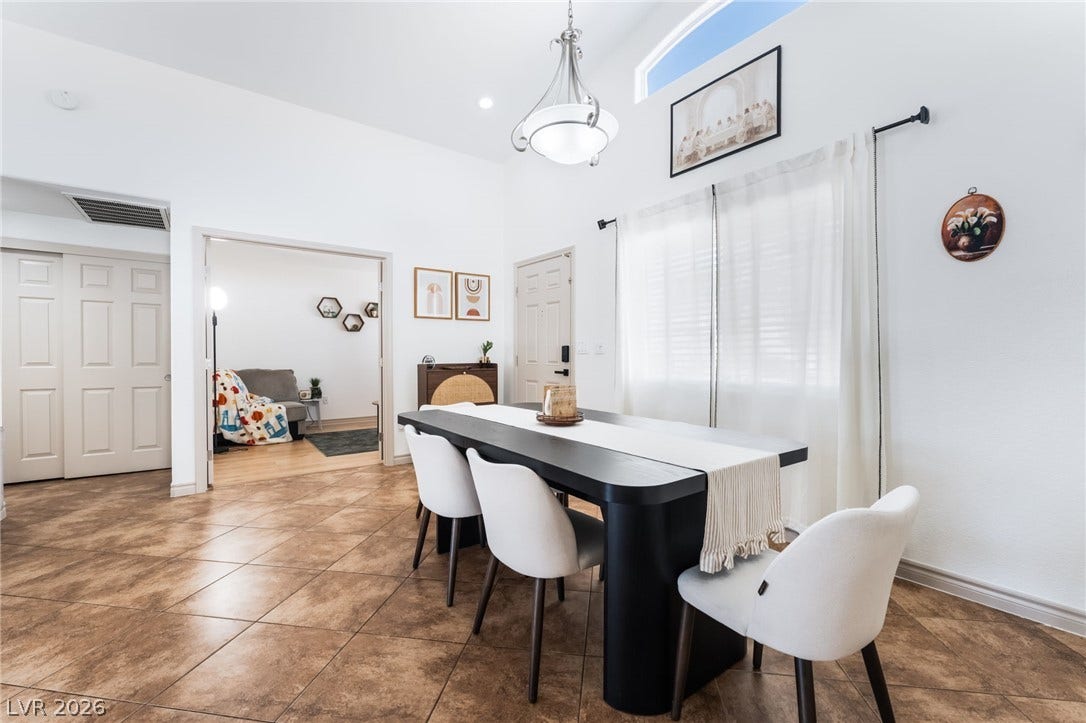 3729 Shimmering Creek Avenue, North Las Vegas, NV 89031 Gleaming tile floors and vaulted ceilings define this airy, open-concept dining area.