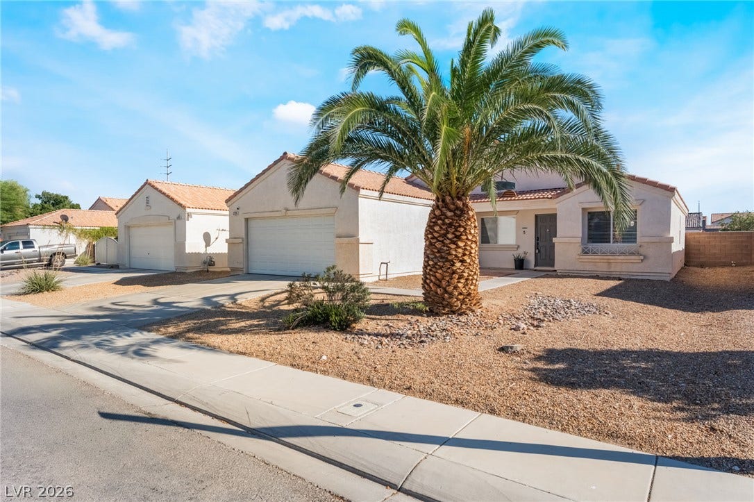 3729 Shimmering Creek Avenue, North Las Vegas, NV 89031 A mature palm tree anchors the low-maintenance desert landscaping of this tile-roofed suburban home.