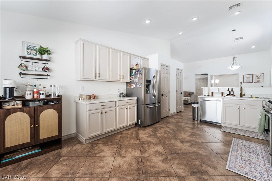 3729 Shimmering Creek Avenue, North Las Vegas, NV 89031 Tiled flooring and recessed lighting accent this kitchen layout.
